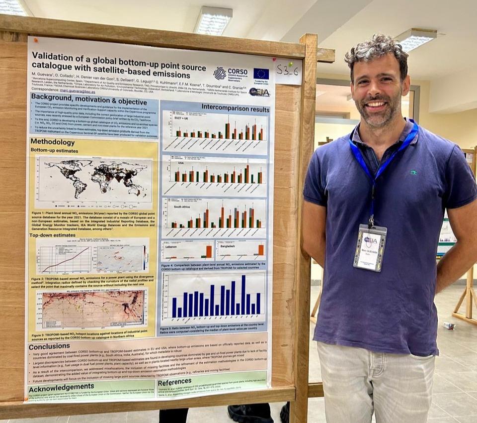 Marc standing next to the poster